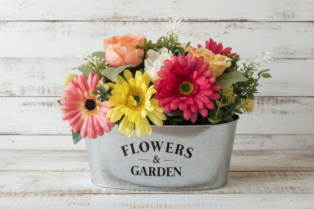 Colorful flower arrangement in a metal container labeled 'Flowers & Garden' on shiplap background.