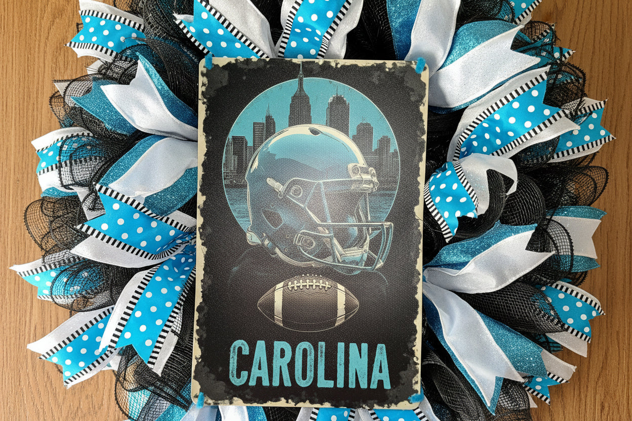 “Handmade Carolina football wreath featuring black, blue, and white mesh ribbon with a helmet and football sign, perfect for sports fan front door decor