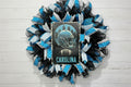 Handmade Carolina football wreath featuring black, blue, and white mesh ribbon with a helmet and football sign, perfect for sports fan front door decor.