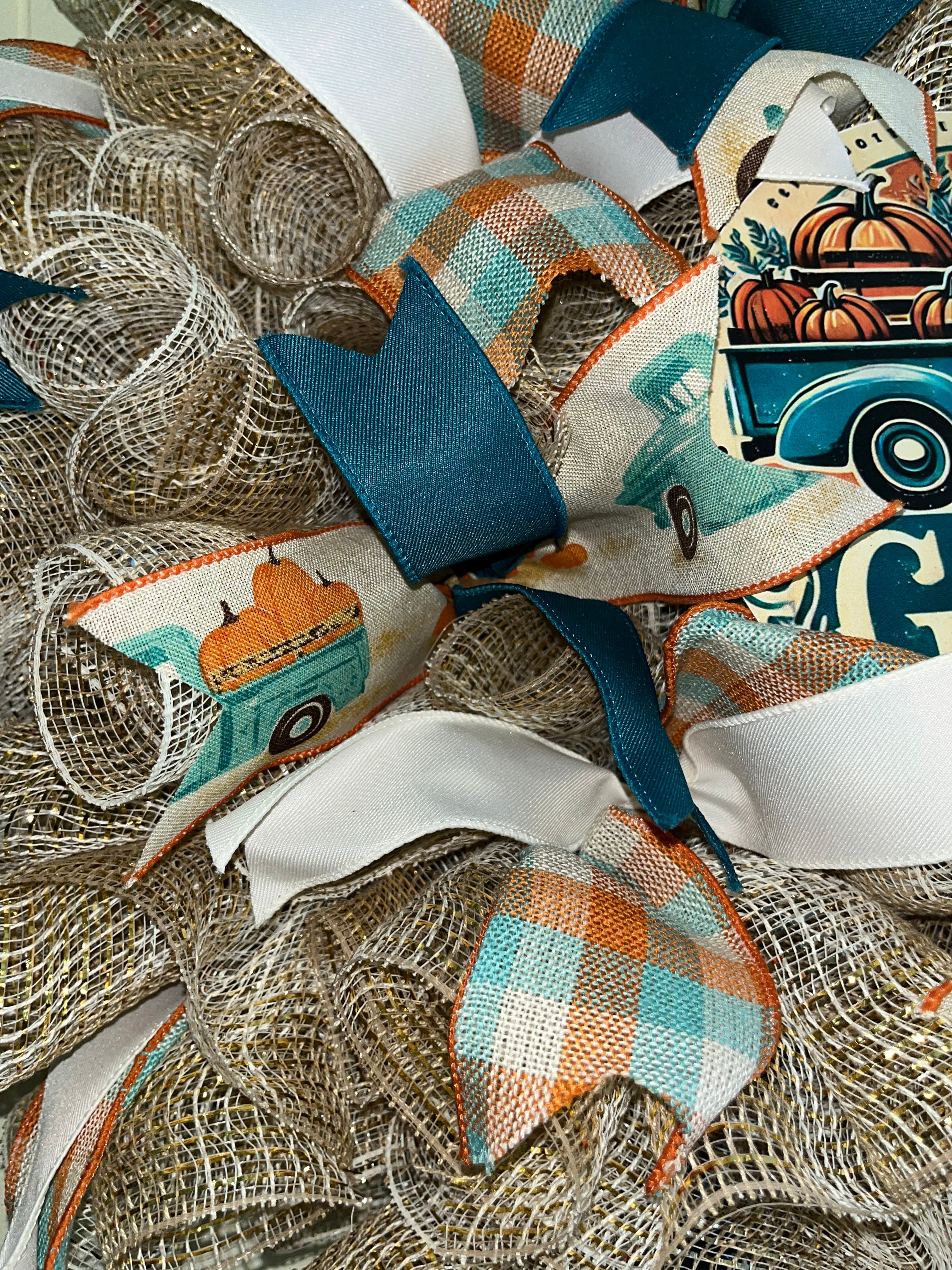 Handmade farmhouse fall wreath with burlap mesh, teal and white ribbon, featuring a vintage truck and ‘Gather’ sign for autumn front door decor.