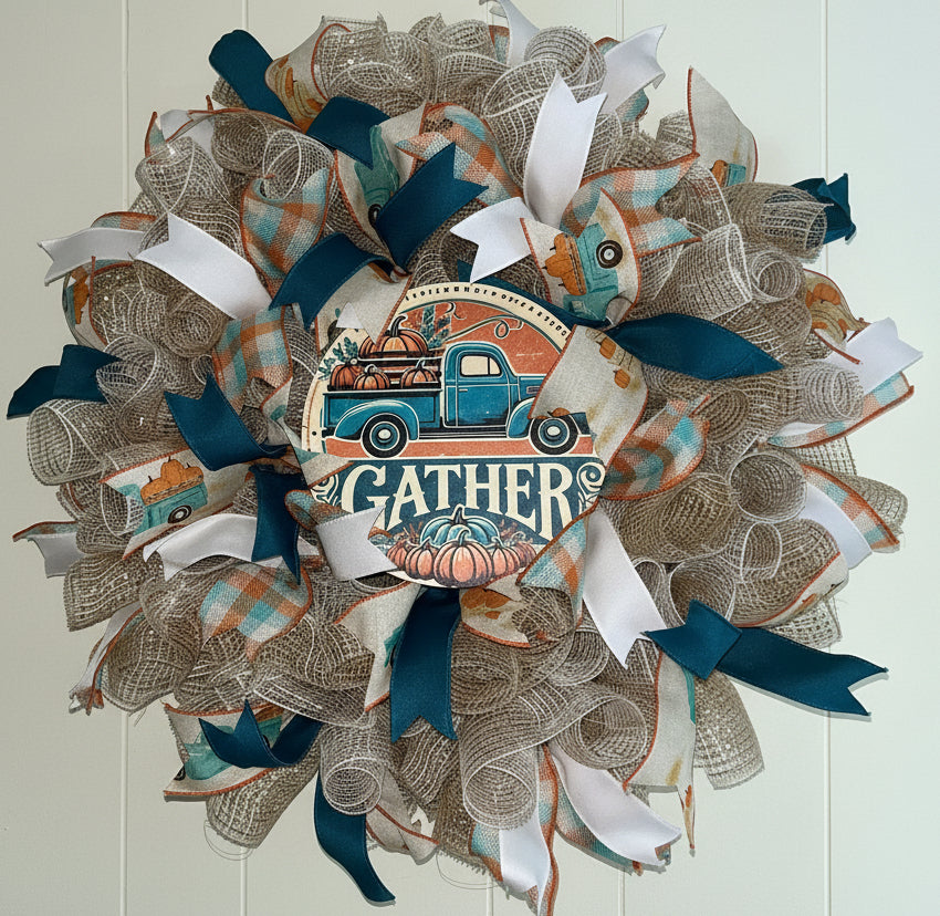 Handmade farmhouse fall wreath with burlap mesh, teal and white ribbon, featuring a vintage truck and ‘Gather’ sign for autumn front door decor.