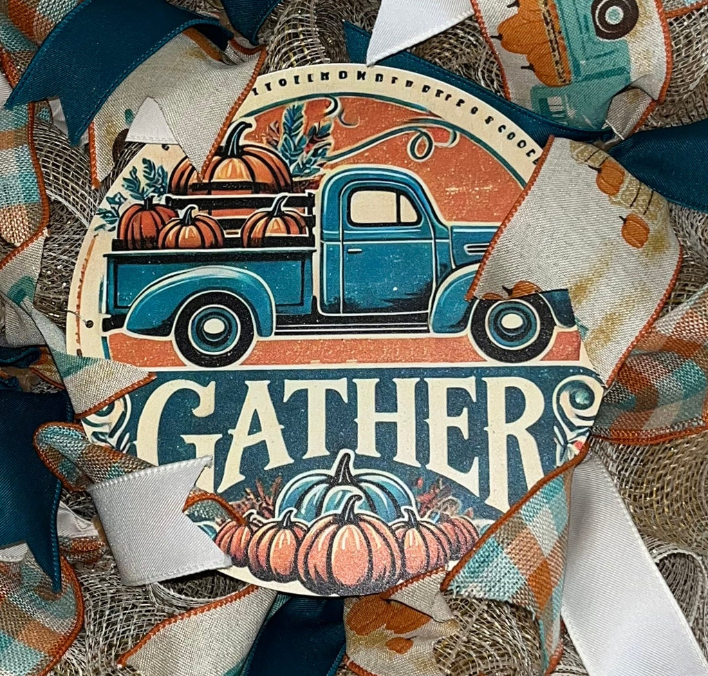 Handmade farmhouse fall wreath with burlap mesh, teal and white ribbon, featuring a vintage truck and ‘Gather’ sign for autumn front door decor.