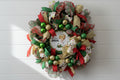Handmade Christmas wreath on an evergreen base with deco mesh, ribbons, ornaments, and a "Happy Birthday Jesus" centerpiece.