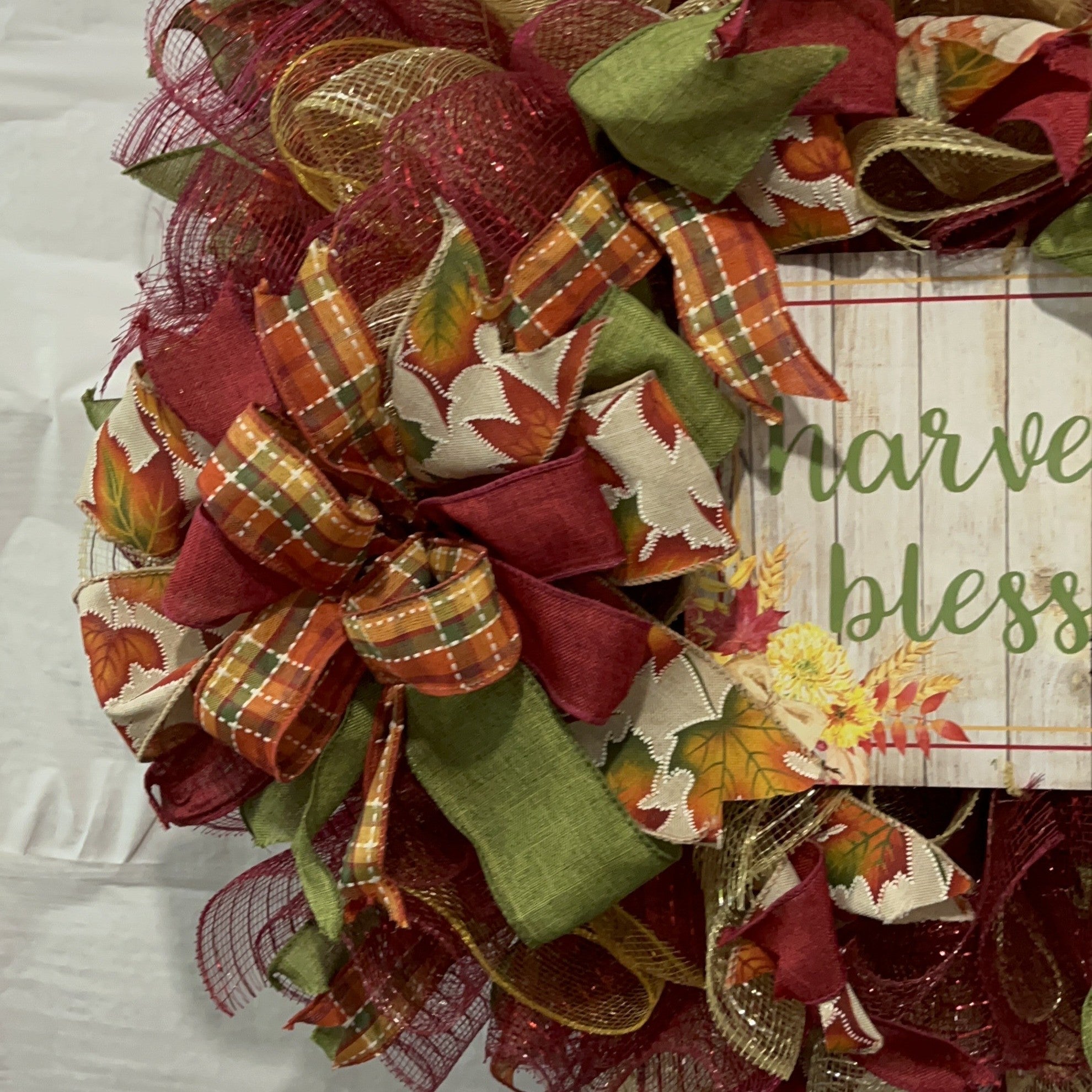 Handmade fall wreath with red, gold, and green mesh featuring a ‘Harvest Blessings’ sign, perfect for autumn and Thanksgiving front door decor.