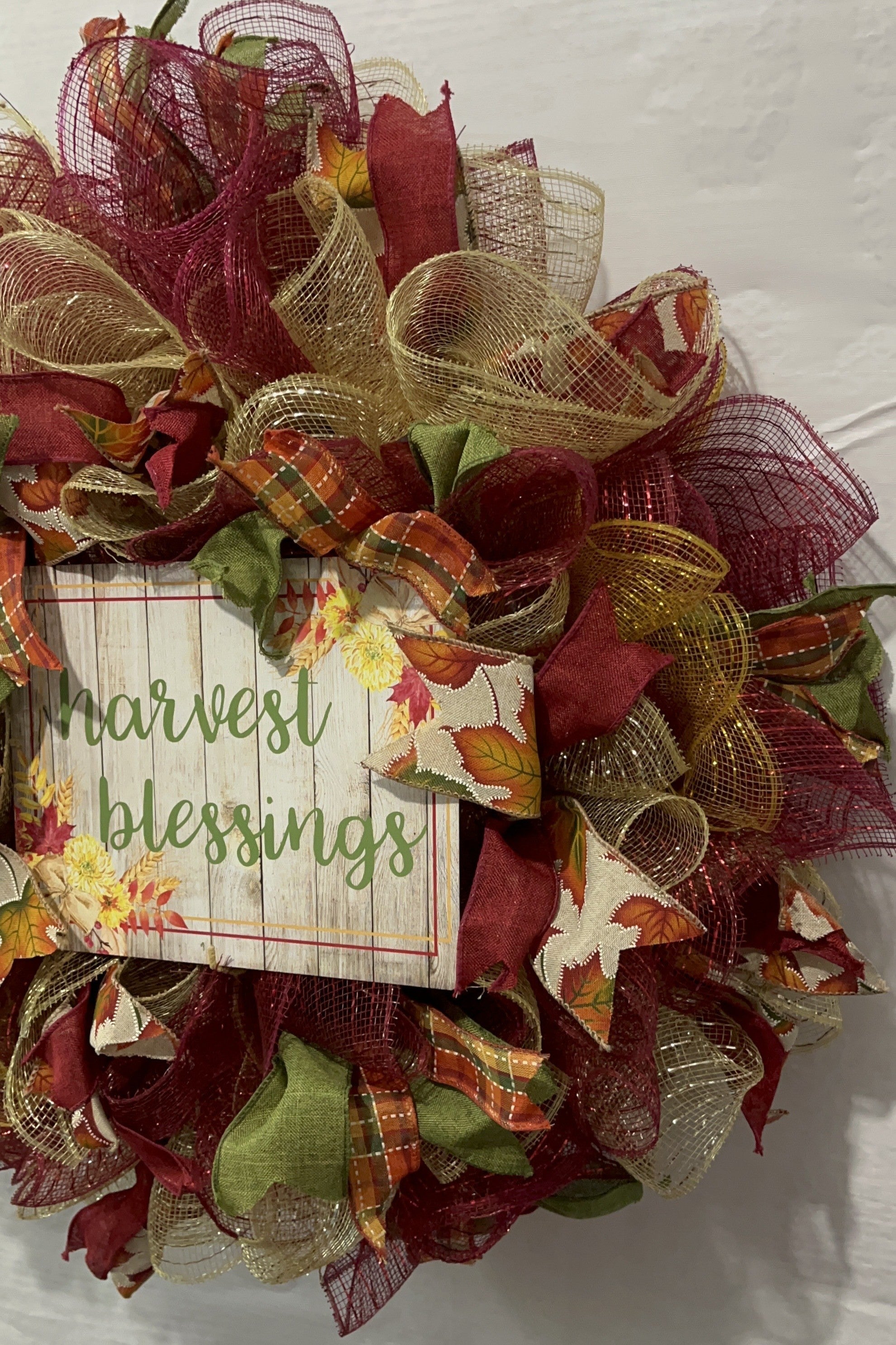 Handmade fall wreath with red, gold, and green mesh featuring a ‘Harvest Blessings’ sign, perfect for autumn and Thanksgiving front door decor.