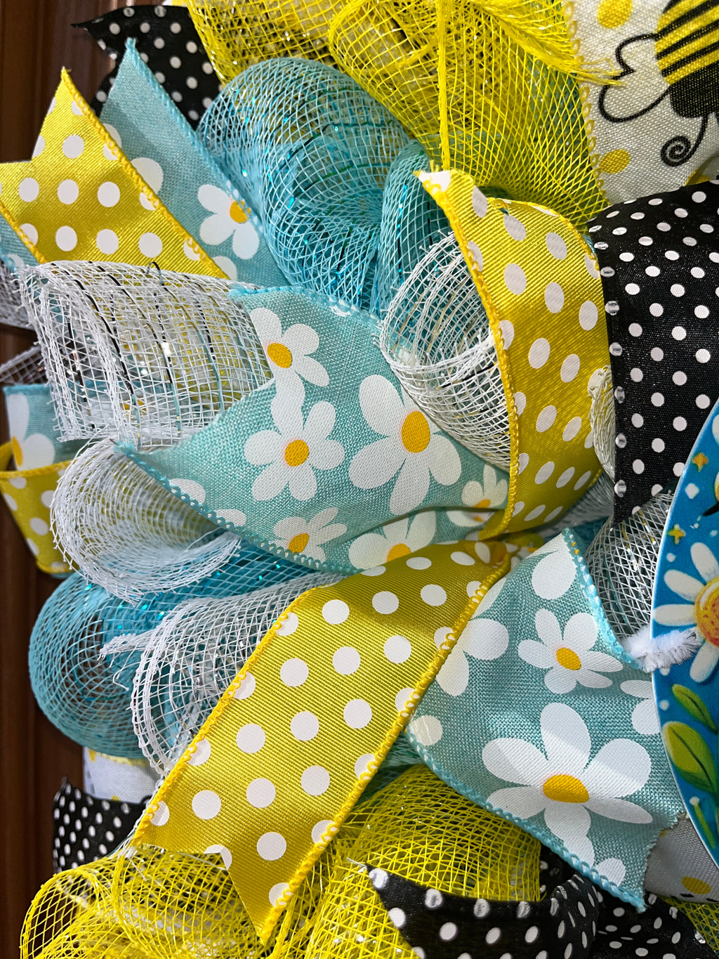 Close-up of decorative mesh and ribbon with polka dots and floral patterns.